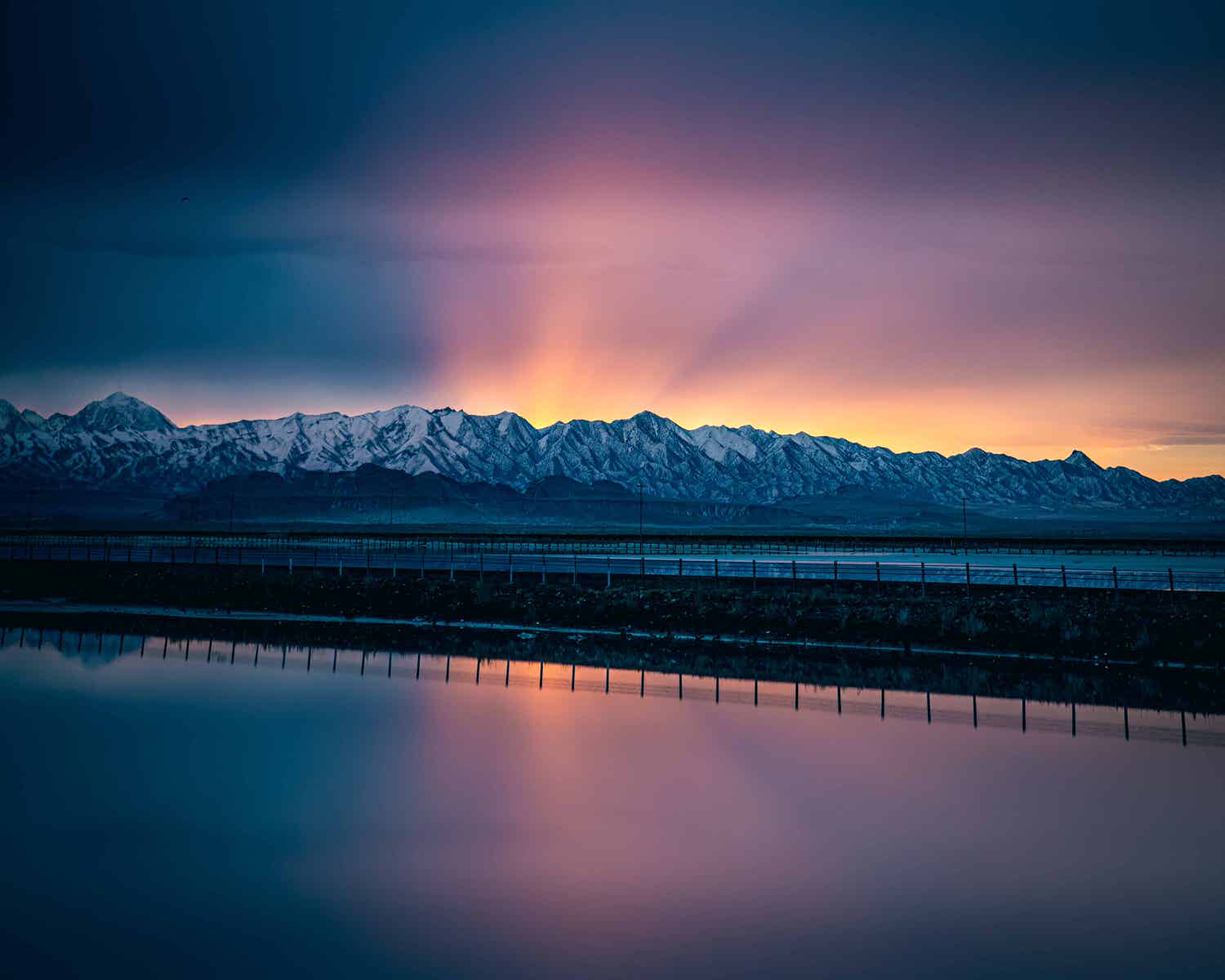 body-of-water-near-snow-capped-mountains-3546778